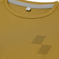 Close-up of a mustard yellow shirt with a tag on the collar (Yellow)