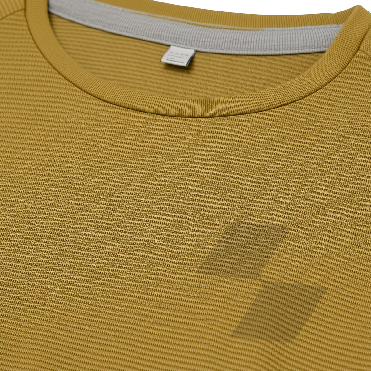 Close-up of a mustard yellow shirt with a tag on the collar (Yellow)