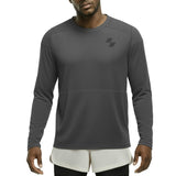 Man wearing a gray long-sleeve athletic shirt with a logo on a white background (Black)