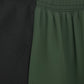 Close-up of a green fabric with a textured black section on the left. (Green)