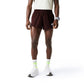 Person wearing brown checkered shorts on a white background (Red)