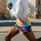Person running on a street wearing colorful shorts and a white long-sleeve shirt. (Black)