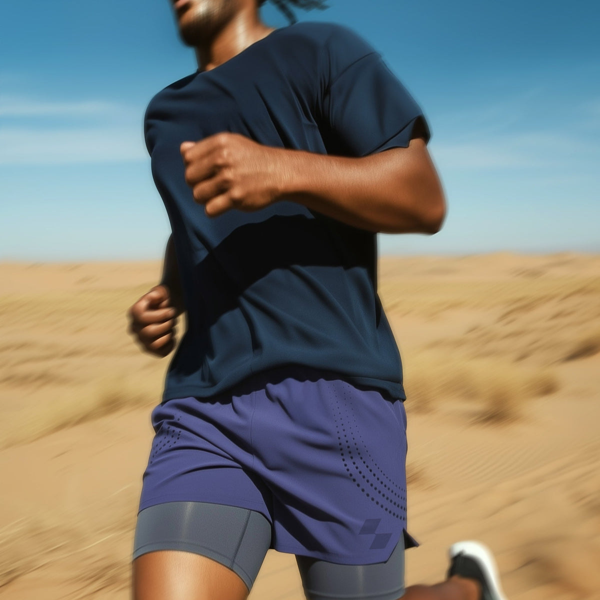 Person running in a desert landscape wearing a navy blue outfit (Blue)